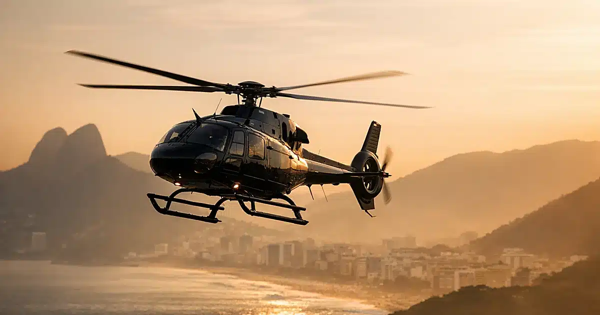 Helicopter in flight against golden sky over Rio de Janeiro coastal landscape at dusk