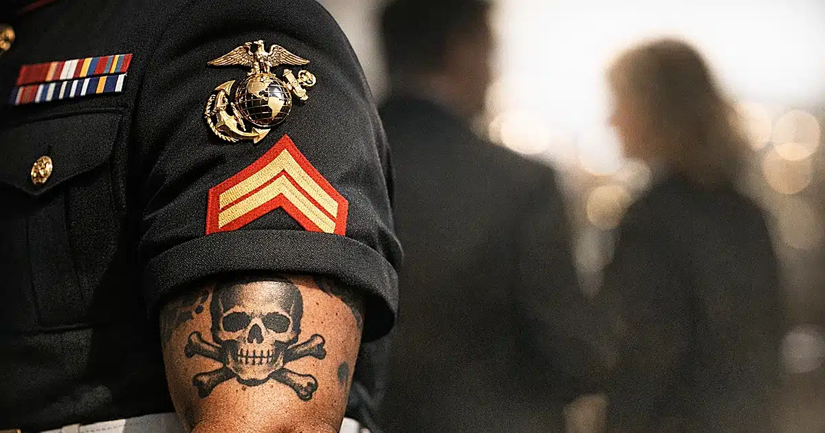 Close-up of Marine Corps dress uniform sleeve with service ribbons in dramatic lighting