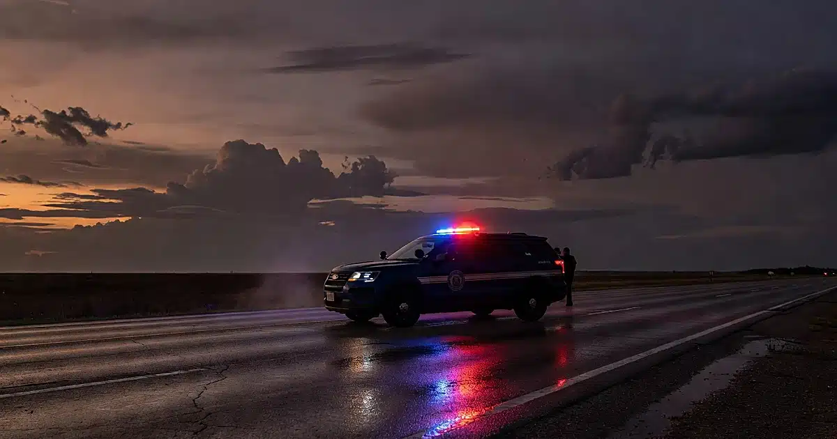 Texas DPS patrol vehicle with emergency lights on empty highway at dusk